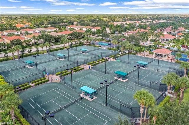 15059 Blue Marlin Ter, Bonita Springs, FL 34135 8Multiple tennis courts, court lighting, covered seating areas, surrounding landscaping, adjacent residential properties