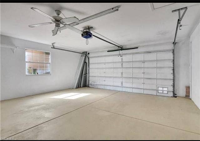 15059 Blue Marlin Ter, Bonita Springs, FL 34135 2 car Garage with a ceiling fan, garage door opener, and a window