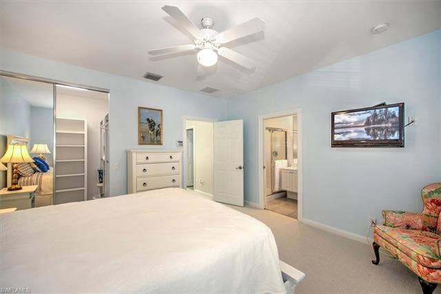 15059 Blue Marlin Ter, Bonita Springs, FL 34135 Upper main suite with en suite Carpeted bedroom featuring a ceiling fan, recessed lighting, and a white six-drawer dresser