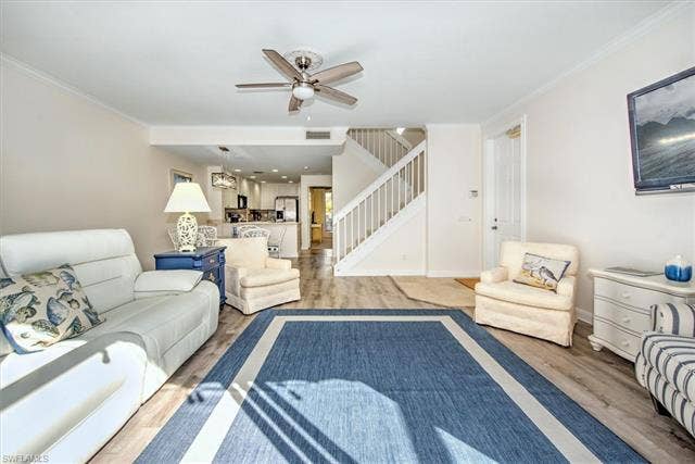 15059 Blue Marlin Ter, Bonita Springs, FL 34135 Bright living area featuring wood-finish waterproof vynil flooring, a ceiling fan, slider taking you to you private courtyard style screened lanai .