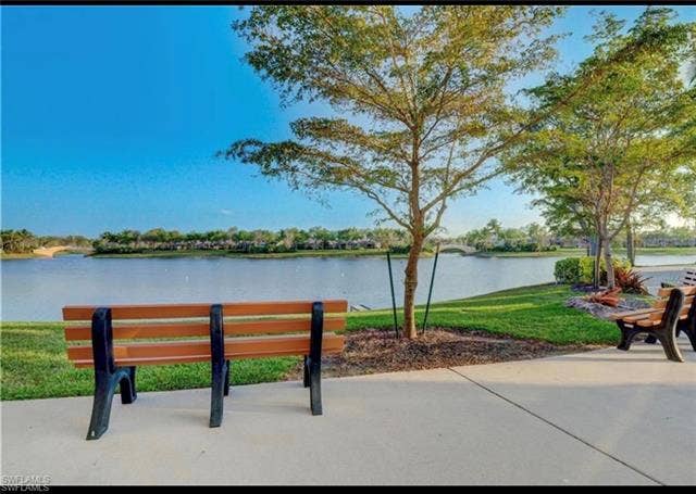 15059 Blue Marlin Ter, Bonita Springs, FL 34135 Waterfront scenery featuring a paved pathway, mature trees, and natural landscaping