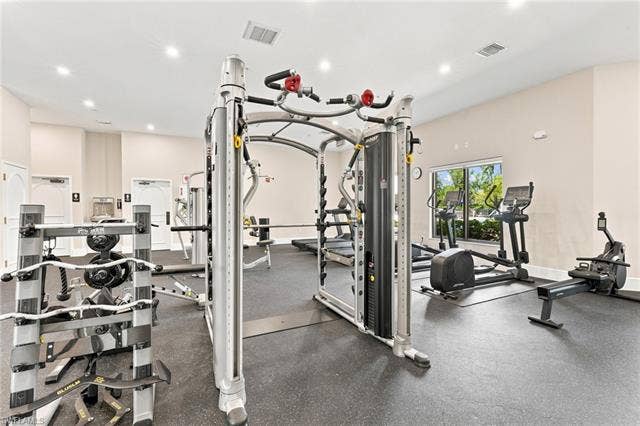 19600 Maddelena Cir, Estero, FL 33967 Fitness area featuring recessed lighting, a rubber-finish floor, and multiple windows