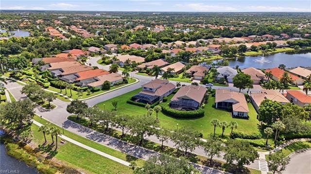 19600 Maddelena Cir, Estero, FL 33967 Residential community with mature landscaping, multiple water features, and varied architectural styles