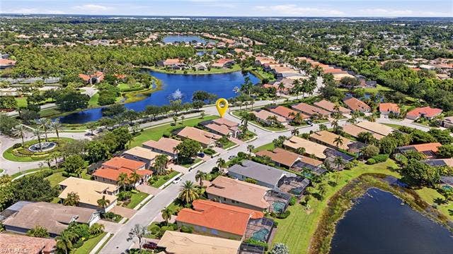 19600 Maddelena Cir, Estero, FL 33967 Residential community with multiple water features, abundant mature landscaping, and an organized street layout