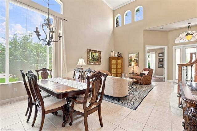 19600 Maddelena Cir, Estero, FL 33967 Two-story living area with high ceilings, large windows, and arched transom windows