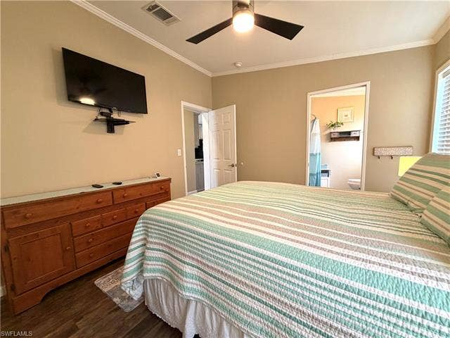 4710 W Lafayette Ln, Estero, FL 33928 Wood-finish flooring with crown molding, ceiling fan, and wall-mounted television