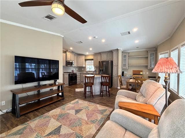 4710 W Lafayette Ln, Estero, FL 33928 Open-concept living area with wood-finish flooring, recessed lighting, and crown molding