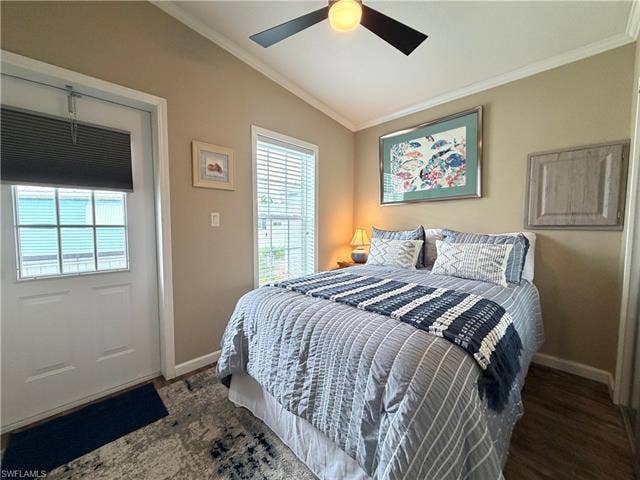 4710 W Lafayette Ln, Estero, FL 33928 Vaulted ceiling with a ceiling fan light fixture, wood-finish flooring, white window blinds, and a paneled exterior door
