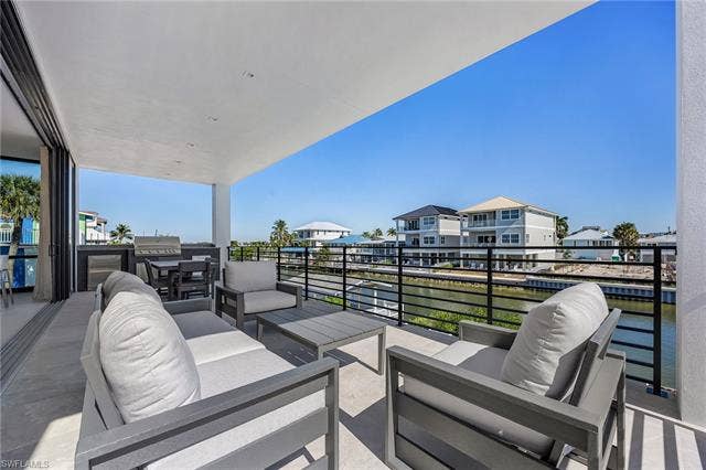 455 Palermo Cir, Fort Myers Beach, FL 33931 View of patio / terrace with an outdoor living space, outdoor dining space, a water view, and a grill
