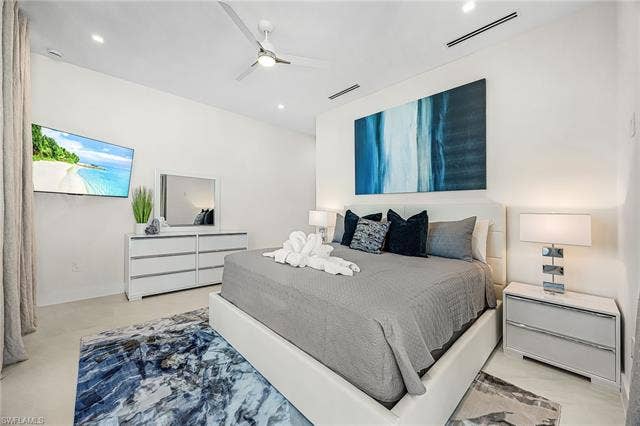 455 Palermo Cir, Fort Myers Beach, FL 33931 Bedroom featuring ceiling fan and baseboards - Virtually Edited Image