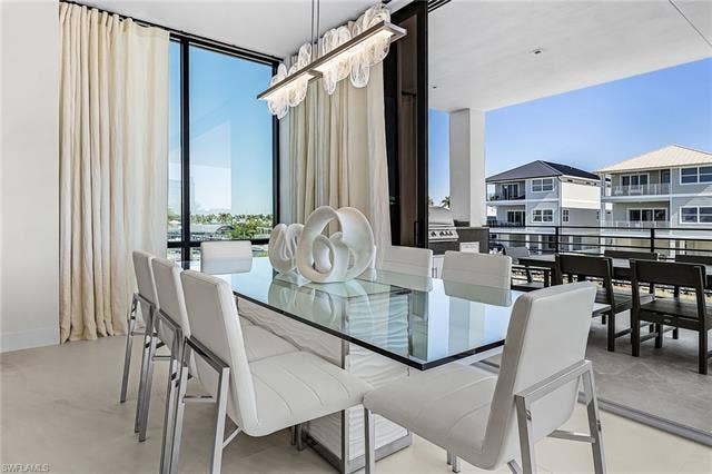455 Palermo Cir, Fort Myers Beach, FL 33931 Dining area with expansive windows - Virtually Edited Image