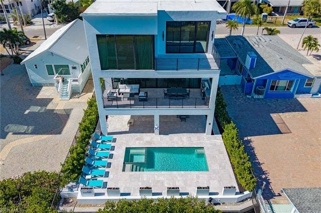 455 Palermo Cir, Fort Myers Beach, FL 33931 Aerial view of residential area with a pool - Virtually Edited Image