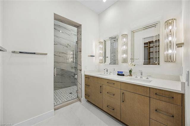 455 Palermo Cir, Fort Myers Beach, FL 33931 Bathroom featuring double vanity and a marble finish shower - Virtually Edited Image