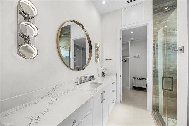 455 Palermo Cir, Fort Myers Beach, FL 33931 Full bath with a spacious closet, vanity, and a stall shower - Virtually Edited Image