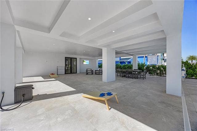 455 Palermo Cir, Fort Myers Beach, FL 33931 View of patio / terrace with outdoor dining area - Virtually Edited Image