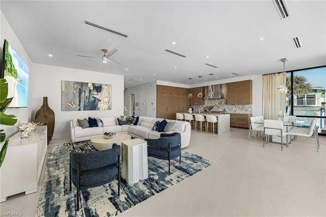 455 Palermo Cir, Fort Myers Beach, FL 33931 Living room with healthy amount of natural light, recessed lighting, and ceiling fan - Virtually Edited Image