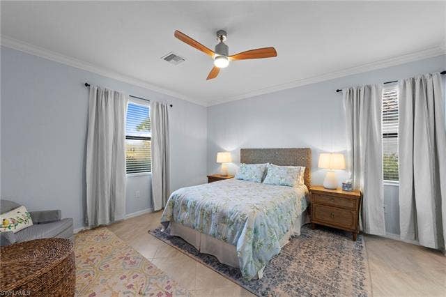 19712 The Place Blvd, Estero, FL 33928 Crown molding, ceiling fan with wood-finish blades, and tiled flooring
