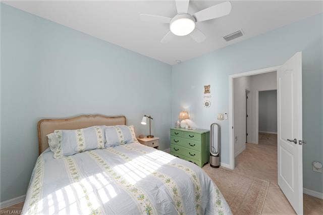 19712 The Place Blvd, Estero, FL 33928 Recessed ceiling with a flush-mount ceiling fan, light blue wall finish, and tile flooring