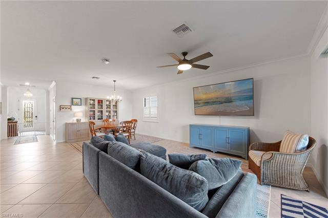 19712 The Place Blvd, Estero, FL 33928 Open-concept living space featuring tile flooring, a ceiling fan, and crown molding