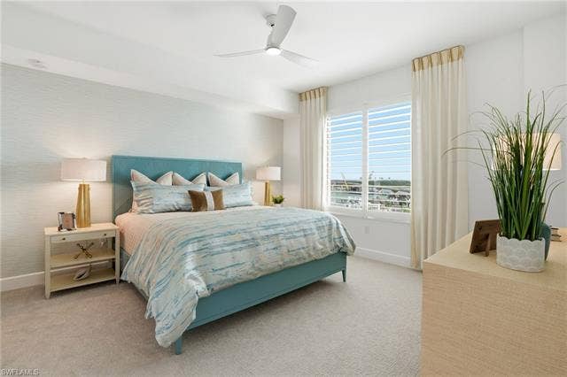 4142 Bay Beach Ln, #904, Fort Myers Beach, FL 33931 Bedroom featuring light carpet and ceiling fan - Virtually Edited Image