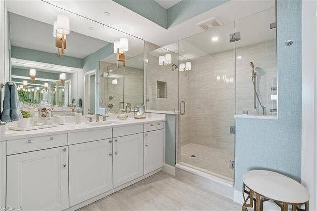 4142 Bay Beach Ln, #904, Fort Myers Beach, FL 33931 Bathroom with a stall shower, vanity, and a chandelier - Virtually Edited Image