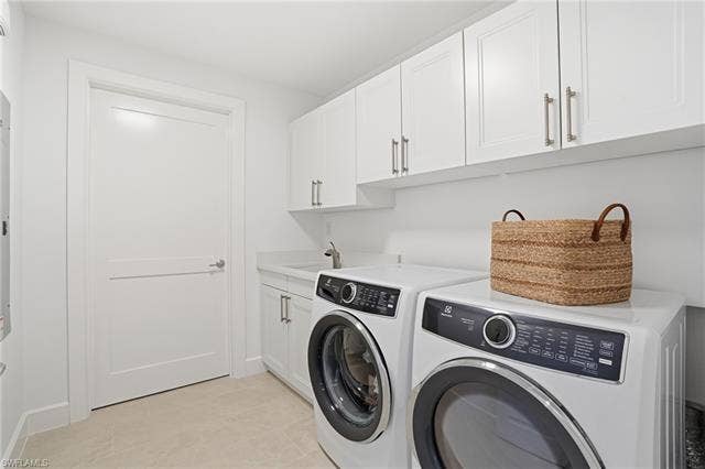 4142 Bay Beach Ln, #904, Fort Myers Beach, FL 33931 Laundry area featuring separate washer and dryer and cabinet space - Virtually Edited Image