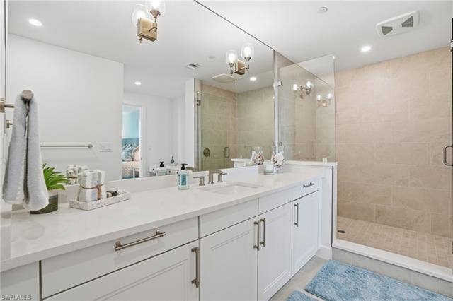 4142 Bay Beach Ln, #904, Fort Myers Beach, FL 33931 Ensuite bathroom with a stall shower, vanity, and recessed lighting - Virtually Edited Image