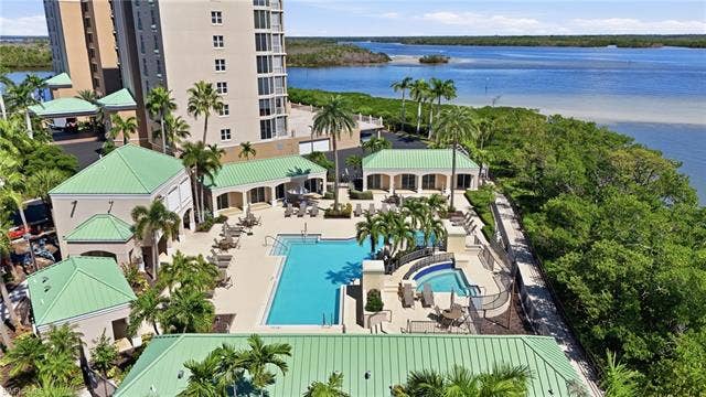4142 Bay Beach Ln, #904, Fort Myers Beach, FL 33931 Bird's eye view of a large body of water and a pool - Virtually Edited Image