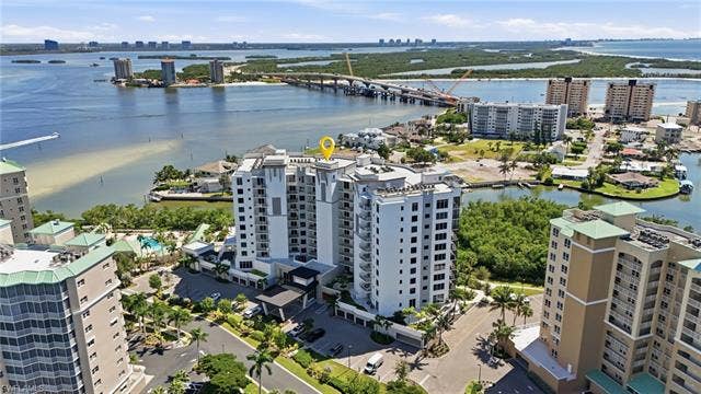 4142 Bay Beach Ln, #904, Fort Myers Beach, FL 33931 View of urban area with apartment complex and a notable bridge - Virtually Edited Image