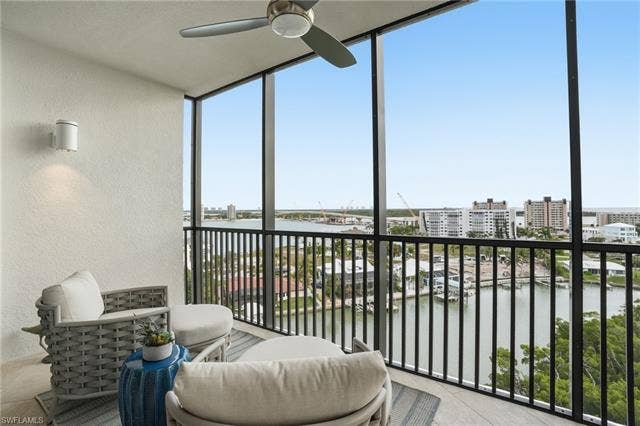 4142 Bay Beach Ln, #904, Fort Myers Beach, FL 33931 Sunroom / solarium featuring a water view - Virtually Edited Image