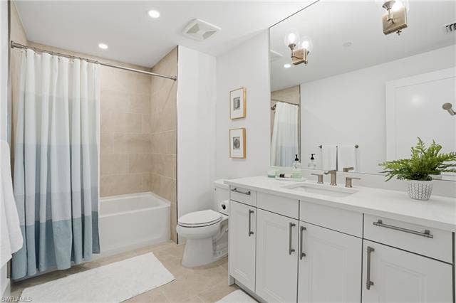 4142 Bay Beach Ln, #904, Fort Myers Beach, FL 33931 Bathroom featuring vanity, shower / bath combination with curtain, light tile patterned floors, and recessed lighting - Virtually Edited Image