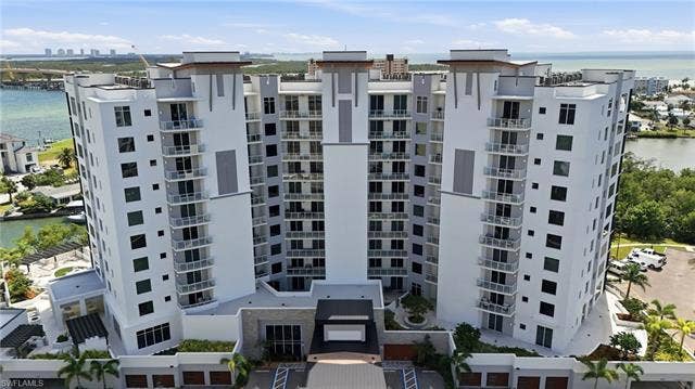 4142 Bay Beach Ln, #904, Fort Myers Beach, FL 33931 View of apartment building / complex featuring a water view - Virtually Edited Image