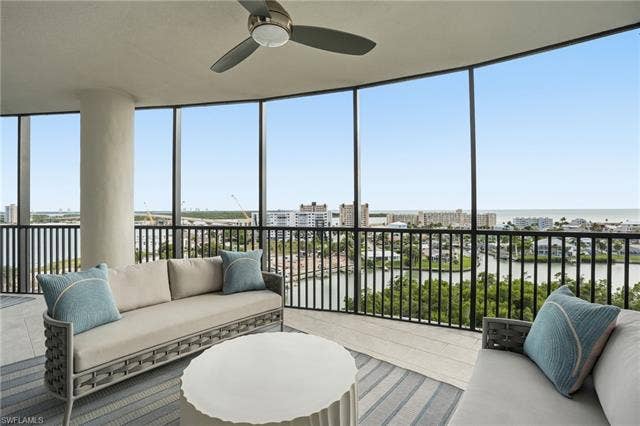 4142 Bay Beach Ln, #904, Fort Myers Beach, FL 33931 Sunroom featuring a water view and expansive windows - Virtually Edited Image