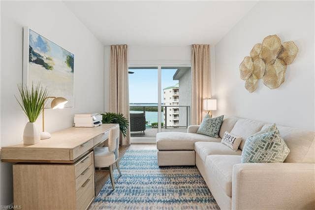 4142 Bay Beach Ln, #904, Fort Myers Beach, FL 33931 Home office with a water view and wood finished floors - Virtually Edited Image
