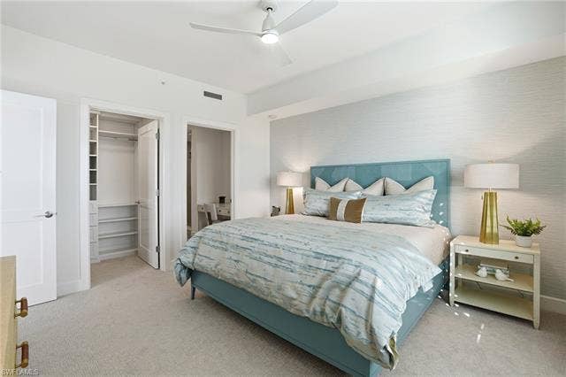 4142 Bay Beach Ln, #904, Fort Myers Beach, FL 33931 Carpeted bedroom with a spacious closet and ceiling fan - Virtually Edited Image
