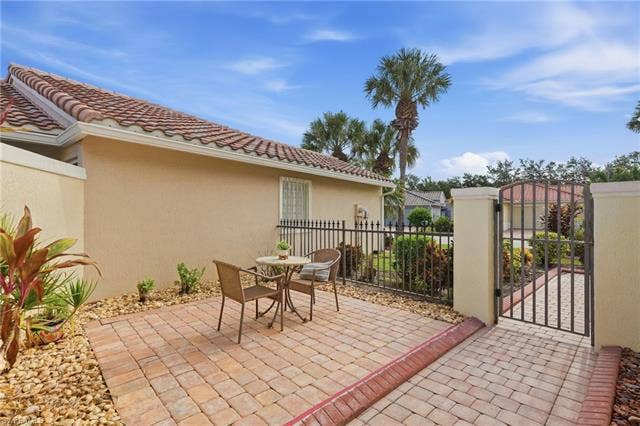 20052 Serene Meadow Ln, Estero, FL 33928 Paved patio area featuring brick-patterned pavers and a decorative stone border