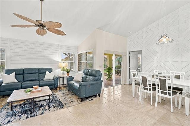 20052 Serene Meadow Ln, Estero, FL 33928 Vaulted ceilings, tile flooring, and sliding glass doors to the exterior
