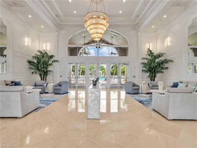 20052 Serene Meadow Ln, Estero, FL 33928 High-volume ceiling with ornate chandelier and recessed lighting