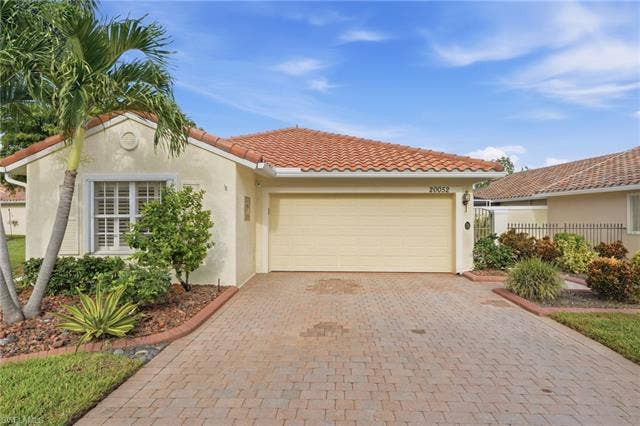 20052 Serene Meadow Ln, Estero, FL 33928 Tiled roof with stucco exterior