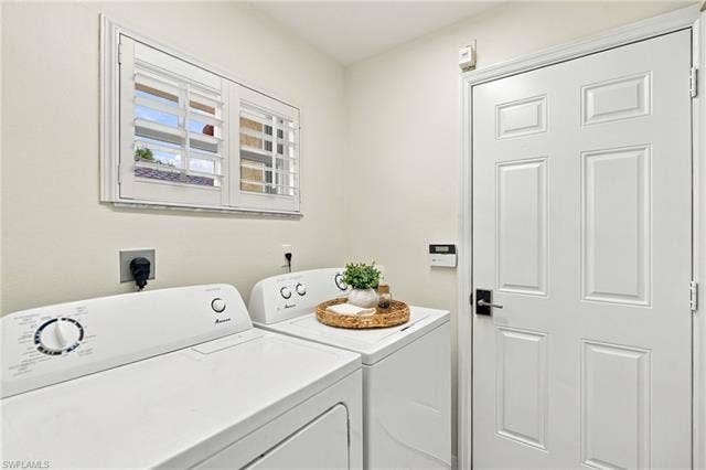 20052 Serene Meadow Ln, Estero, FL 33928 Window with white plantation shutters and trim