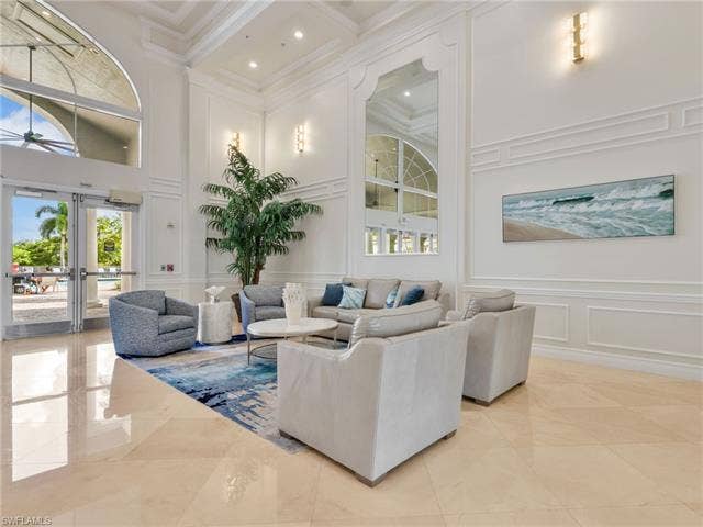 20052 Serene Meadow Ln, Estero, FL 33928 Soaring high ceilings with recessed lighting, decorative wall molding, polished tile flooring, and arched window