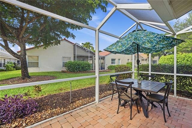 20052 Serene Meadow Ln, Estero, FL 33928 Screened patio featuring brick paver flooring