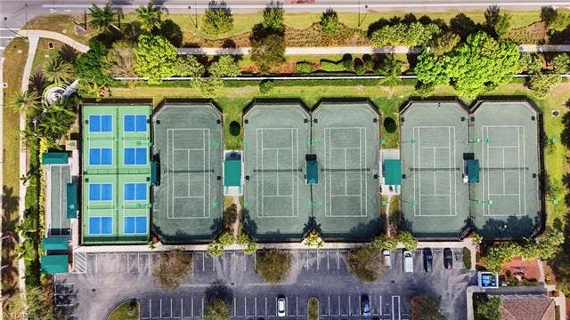 20052 Serene Meadow Ln, Estero, FL 33928 Multiple tennis courts, dedicated pickleball courts, manicured landscaping, and designated parking areas