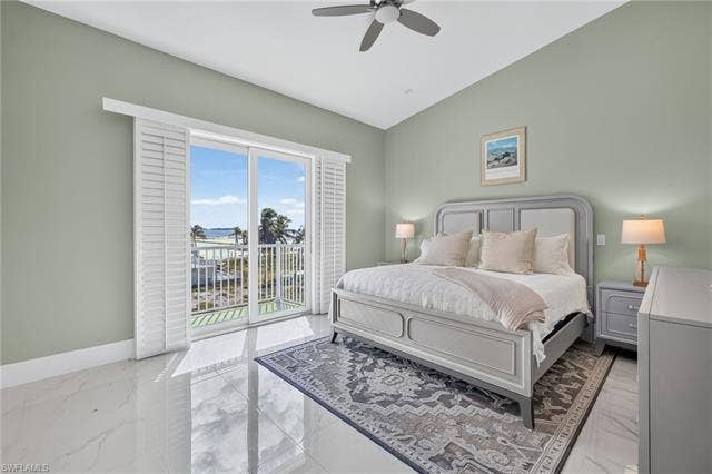 61 Mango St, Fort Myers Beach, FL 33931 Vaulted ceiling with a ceiling fan, sliding glass doors with plantation shutters, balcony access, and polished tile flooring - Virtually Edited Image