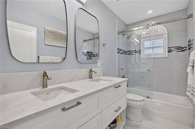 61 Mango St, Fort Myers Beach, FL 33931 Dual vanity with integrated sinks and stone countertops - Virtually Edited Image