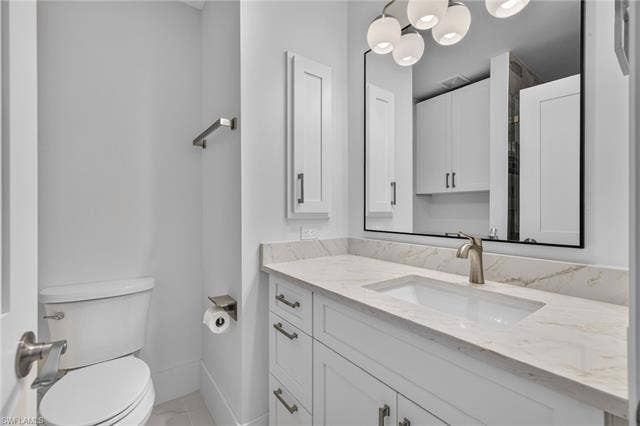 61 Mango St, Fort Myers Beach, FL 33931 Modern bathroom featuring a floating vanity with an integrated rectangular sink, light stone countertop, and polished chrome faucet - Virtually Edited Image