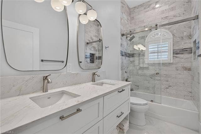 61 Mango St, Fort Myers Beach, FL 33931 Dual vanity with undermount sinks and light-toned countertops - Virtually Edited Image