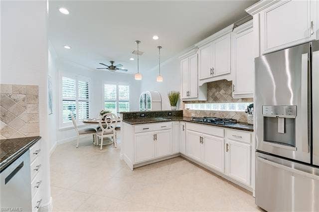 23472 Sanabria Loop, Bonita Springs, FL 34135 Extra Overhead lighting and glass block window bathes the kitchen in light