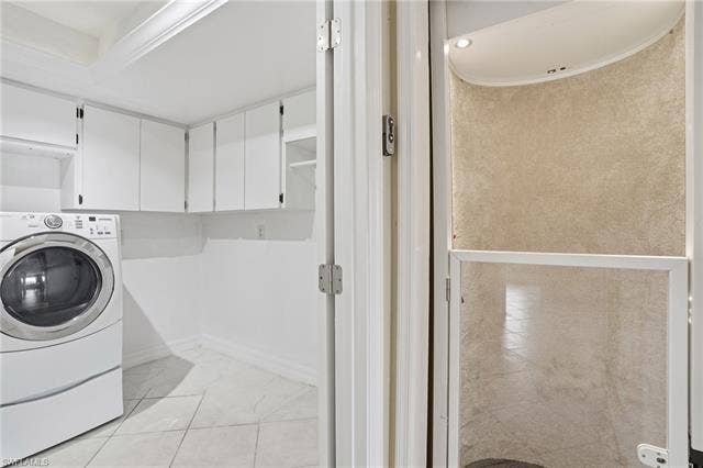 48 Fairview Blvd, Fort Myers Beach, FL 33931 Laundry area with washer / dryer and cabinet space - Virtually Edited Image