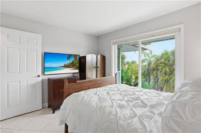48 Fairview Blvd, Fort Myers Beach, FL 33931 Tiled bedroom with access to exterior - Virtually Edited Image
